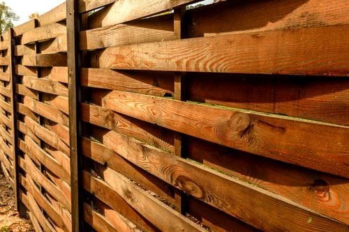 Close-up of warm horizontal cedar fence boards showing natural wood grain
