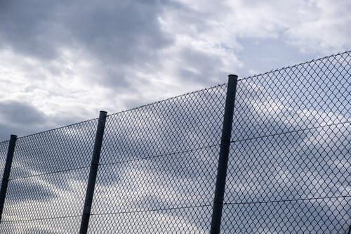 Galvanized chain link fence installed around a property perimeter by Fast Fences LLC in Norfolk VA