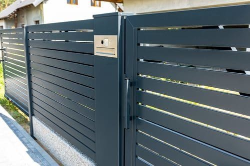 Custom-designed modern horizontal slat fence and matching entry gate built by Fast Fences LLC