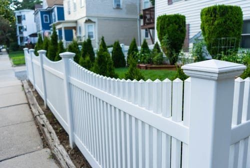 White vinyl picket fence installed along a Hampton Roads residential front yard by Fast Fences LLC